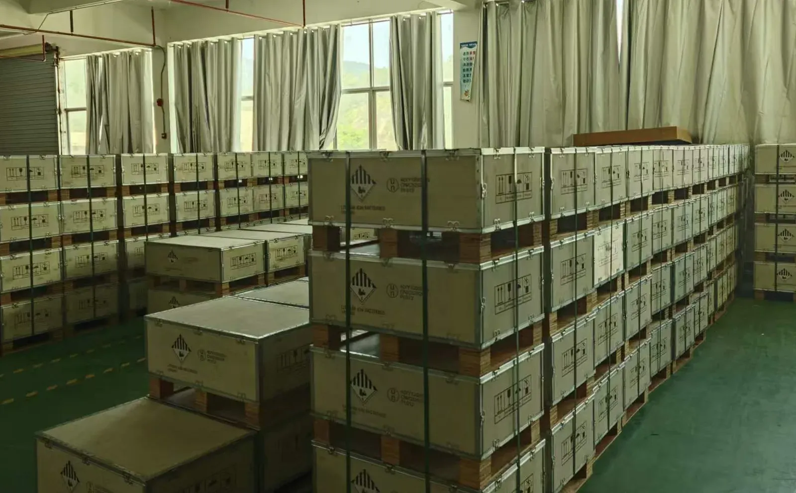 UN-certified export crates stacked beside finished battery packs ready for shipment